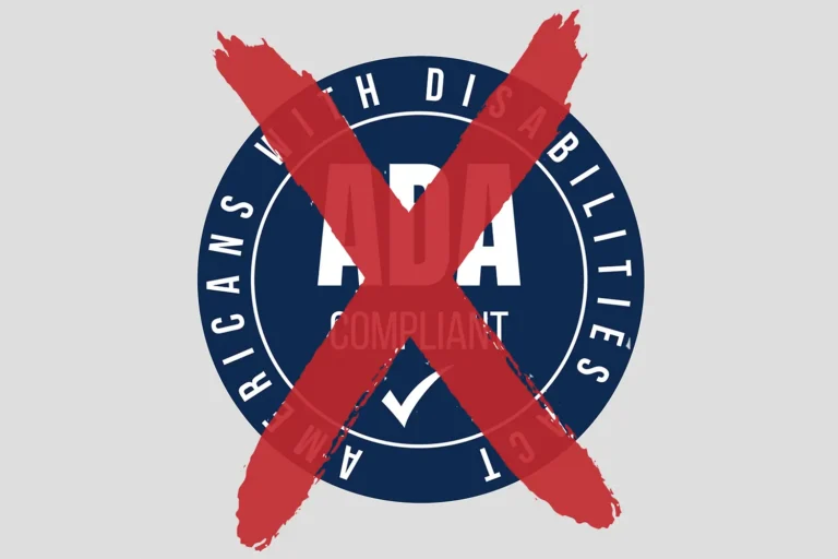 An ADA Compliant badge with a large red X across it